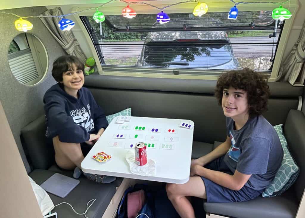 Kids playing Cards inside Teardrop Trailer