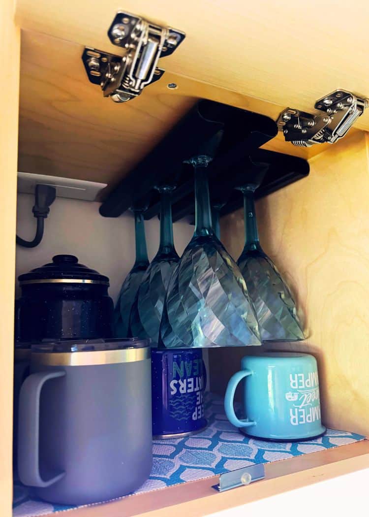 Cupboard with wine glasses and insulated mugs