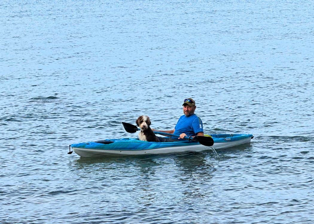 Man and dog in kayak