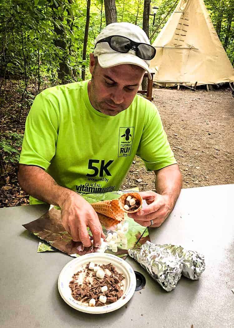 John making smores at the campsite