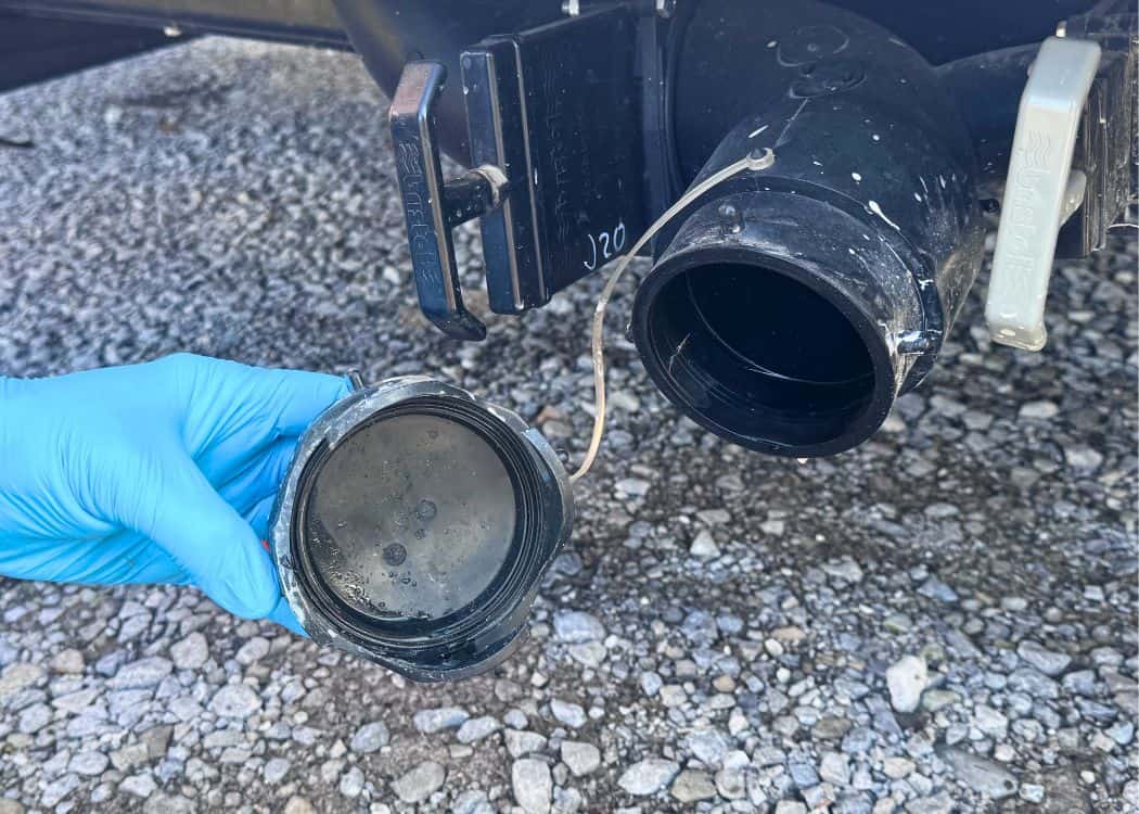 Dump Station - Removing drain cap from trailer