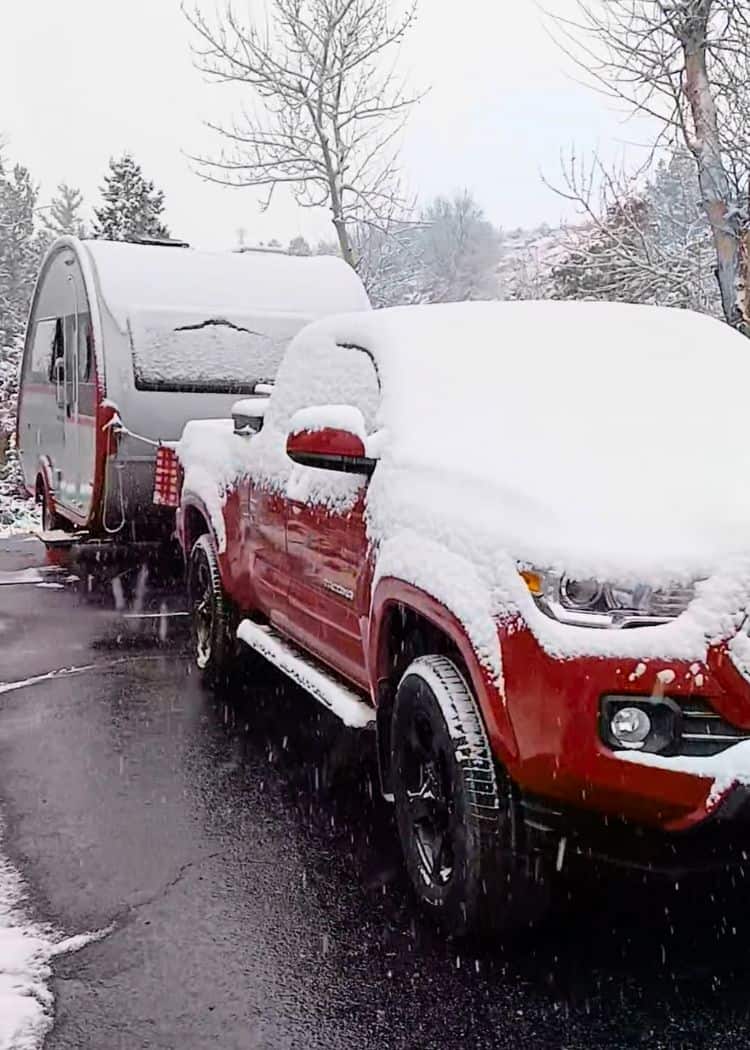 Winter Camping in a Teardrop - TAB 400 with tow vehicle covered in snow