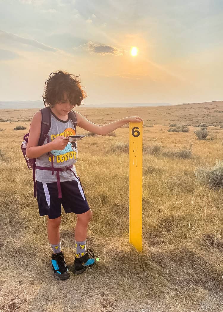 Grasslands NP - Boy looking at activity card while on trail