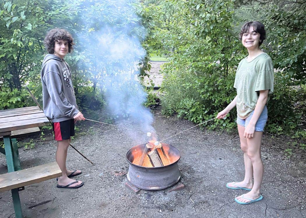 What We Eat While Camping - Kids roasting marshmallows at the campsite